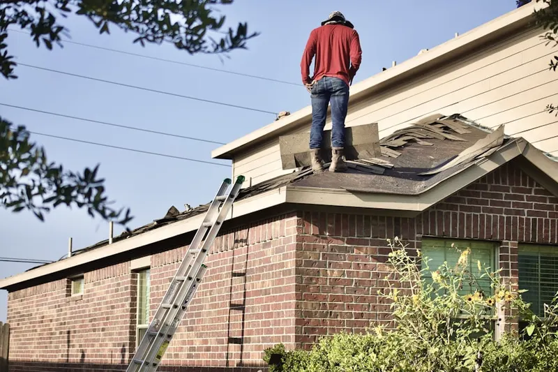 Professional roofer working on a residential roof in Milliken